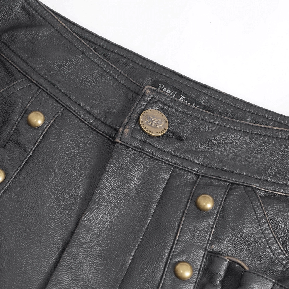 Close-up detail of waistband featuring bronze snap buttons, leather grain texture, and quality construction on gothic pants