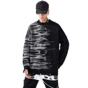 Front view of black gothic patchwork distressed knit oversized sweater on male model, white background, showing abstract print and frayed details