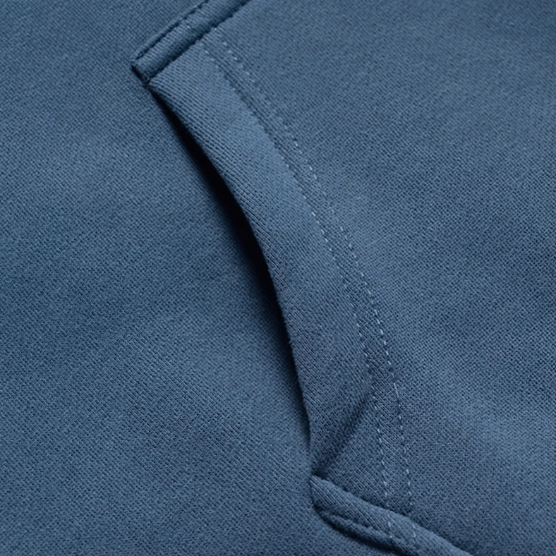 Back view of black and gray patchwork fleece hoodie showing color-block raglan design