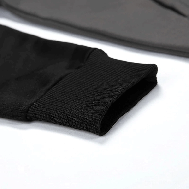 Raglan sleeve construction detail showing patchwork seaming on gothic hoodie