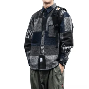 Dark blue gothic patchwork plaid button-up shirt, oversized silhouette worn with backpack strap visible, side three-quarter view