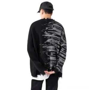 Back view of gothic oversized sweater featuring matching abstract print pattern and distressed frayed hem