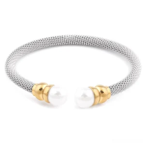 Gothic pearl cuff bracelet with dual-tone stainless steel and white simulated pearls - front flat lay view