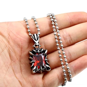 Gothic pendant necklace with bead chain displayed on hand - close-up side view showing spiky metal frame