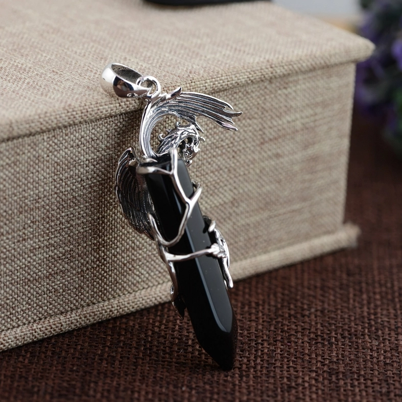 Black obsidian phoenix gothic pendant displayed in luxury gift box with brown linen fabric, showing vintage silver frame detail