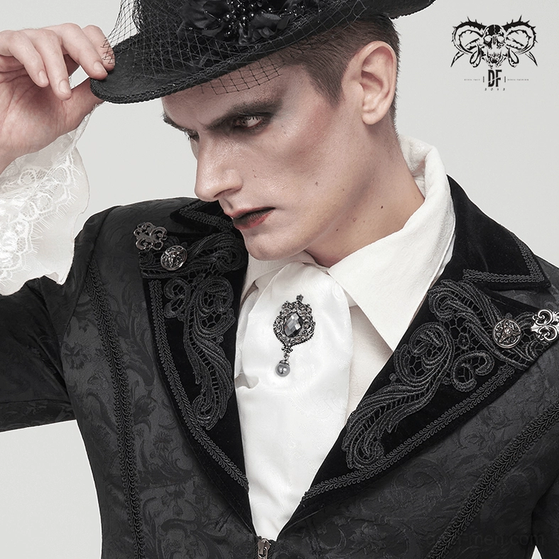 Goth performer adjusting white ascot with crystal brooch wearing top hat and formal suit