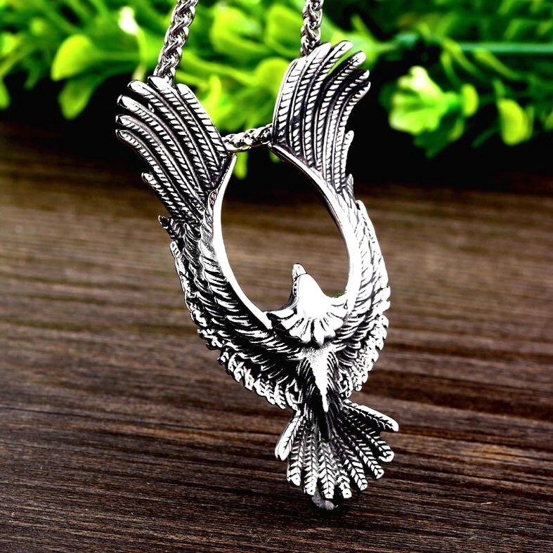 Close-up angled view of phoenix pendant feather carving with gothic aesthetic shadow details