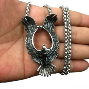 Stainless steel gothic phoenix pendant necklace held in human hand showing actual size and scale