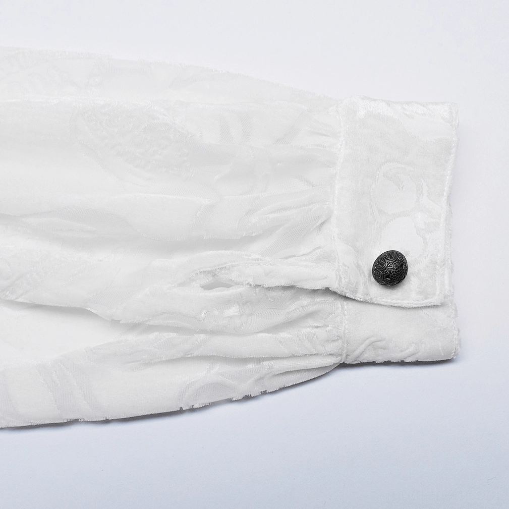 Close-up of gothic shirt cuff showing dark metal mushroom button gathered velvet sleeve fabric