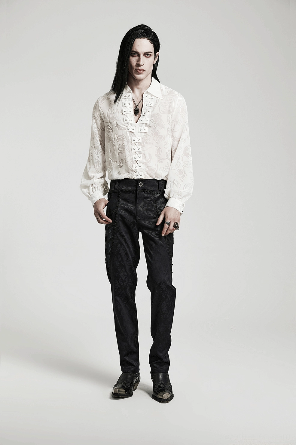 Front lace-up closure of white gothic velvet shirt with metal eyelets and suede loop accents
