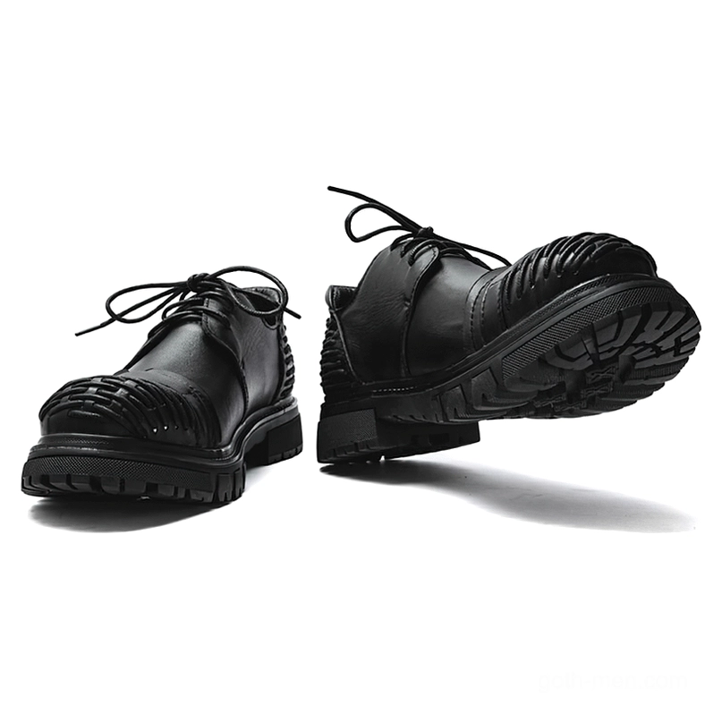 Black gothic platform work boots front view displaying thick rubber lug sole lace-up closure