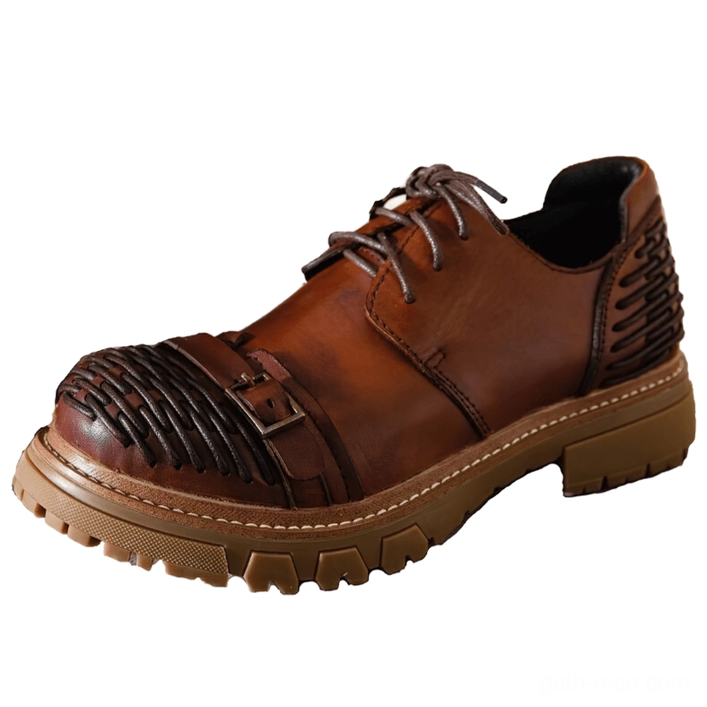 Brown leather gothic platform boots side view showing tan rubber lug sole and strap buckle detail