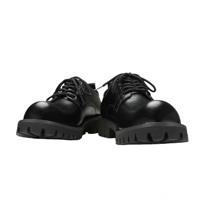 Front low-angle view of black gothic platform derby boots with round closed toe and glossy leather