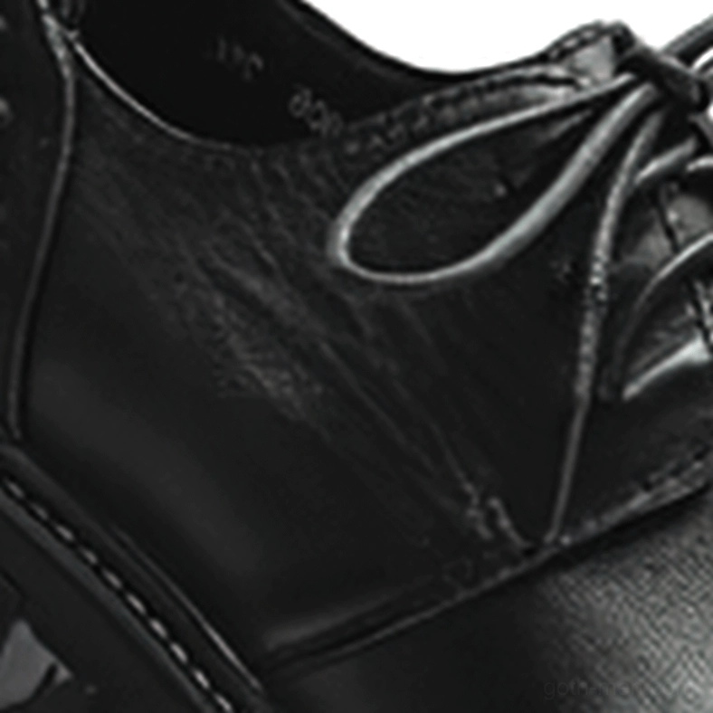 Close-up macro detail of genuine leather texture stitched seams and lacing on gothic boots