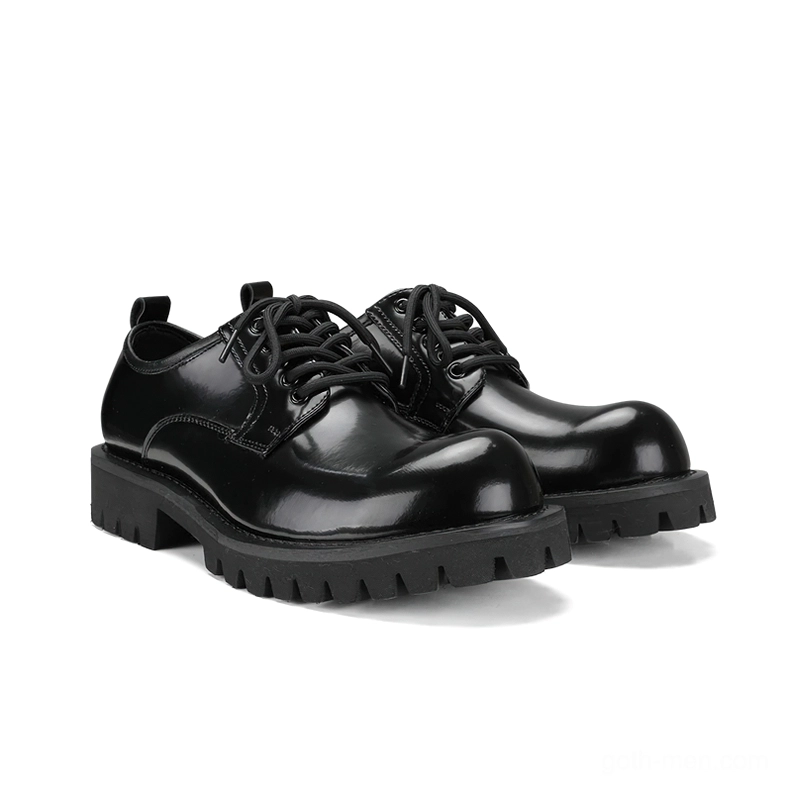 Black leather gothic platform derby boots three-quarter front view showing glossy finish and thick lug sole