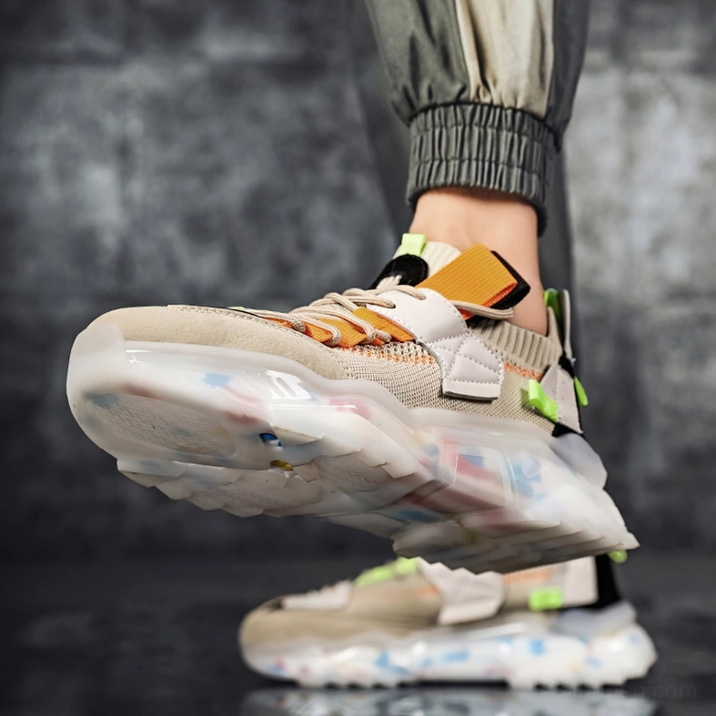 Khaki gothic platform sneakers on model's feet with stacked pair behind showing thick transparent sole