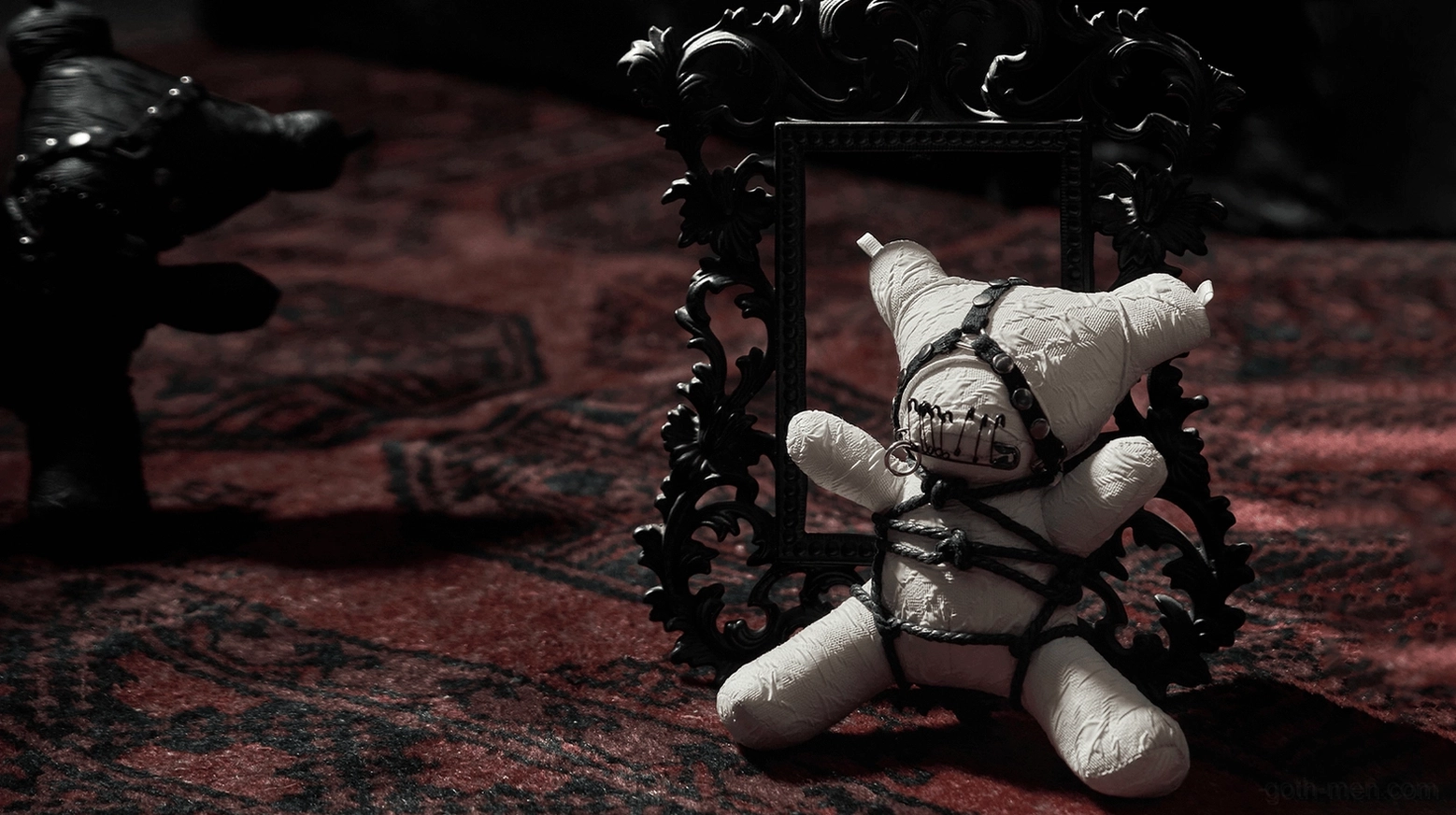 Collectible gothic plush ornament featuring intricate black bondage harness and detachable metal chain strap