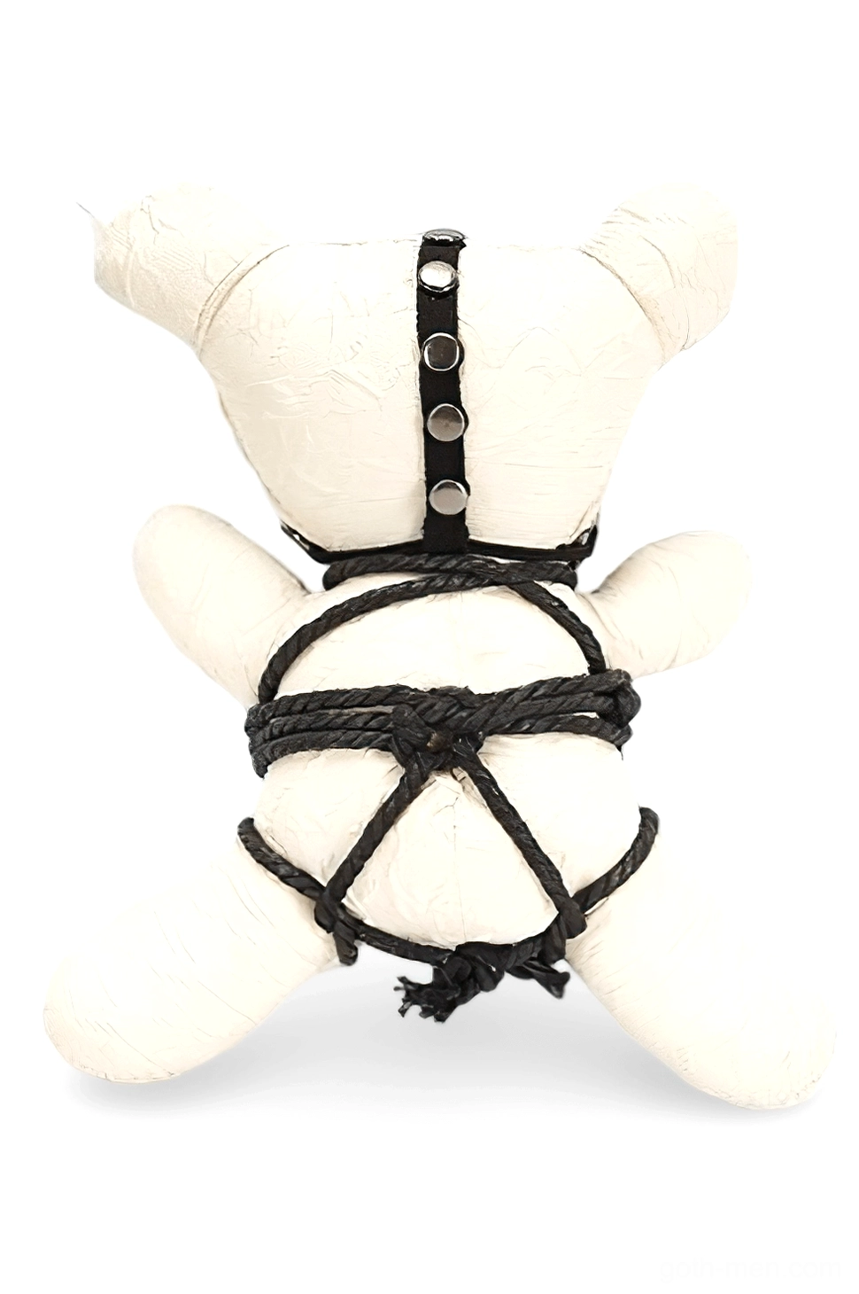 Black canvas harness with round metal rivets on cream plush ornament, rear perspective