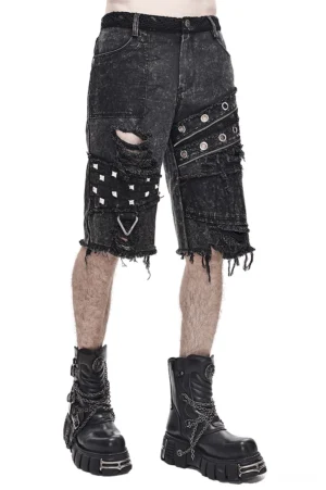 Black denim gothic punk shorts with metal rivets and distressed rips front side angle view on male model studio photography