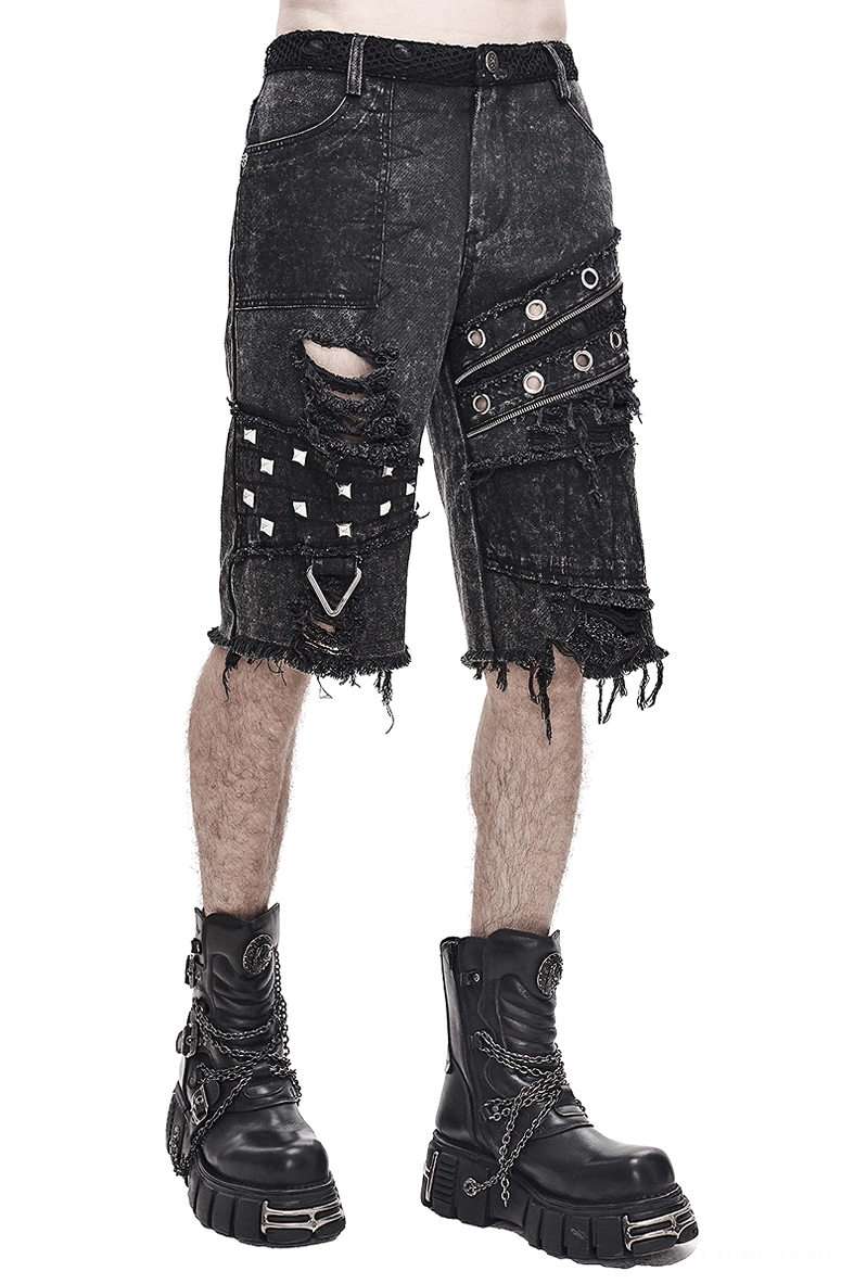 Black denim gothic punk shorts with metal rivets and distressed rips front side angle view on male model studio photography