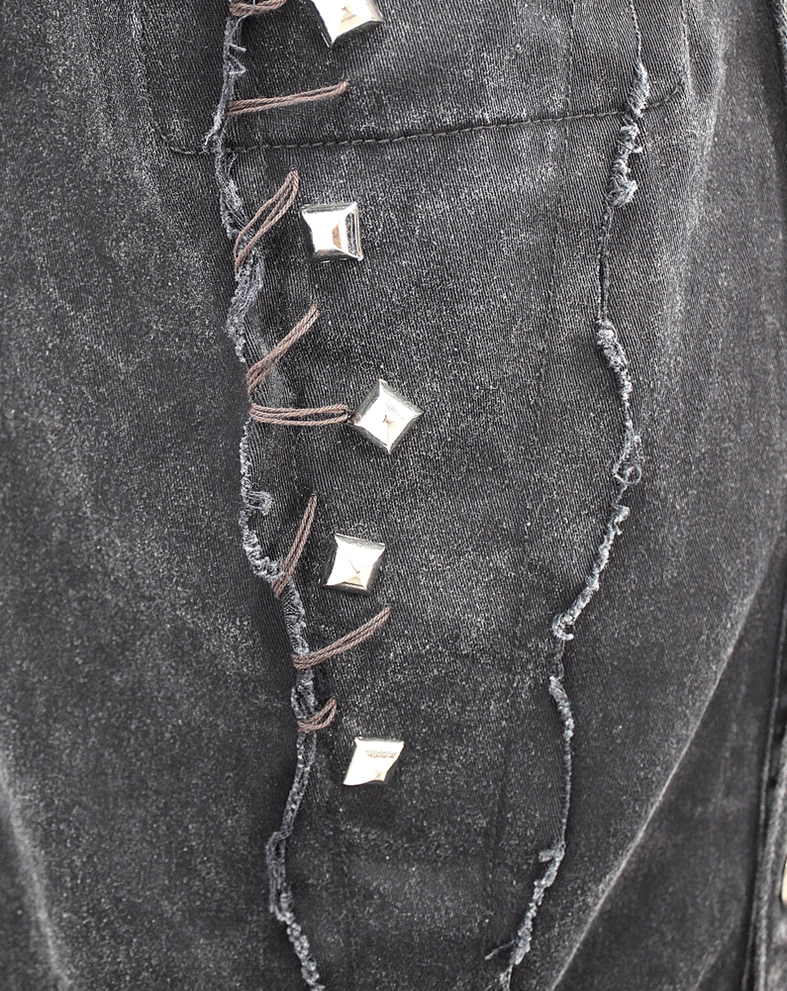 Gothic punk black denim vest displaying hem fraying and overall silhouette on mannequin