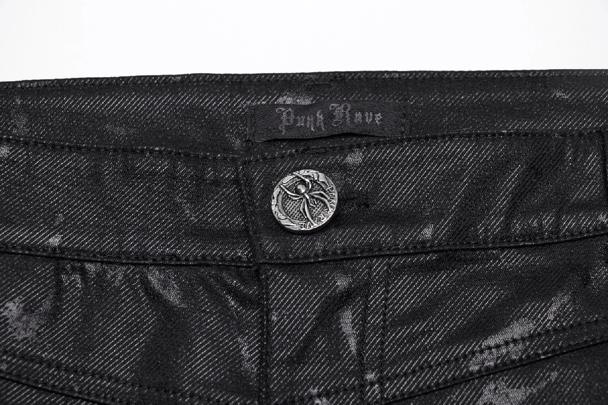 Close-up waist detail gothic punk jeans embossed metal button marbled black fabric