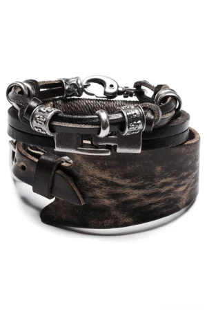 Gothic punk leather bracelet stack set flat lay, distressed brown-black cowhide with antique silver metal buckle and clasp hardware, three-piece alternative fashion bracelet collection