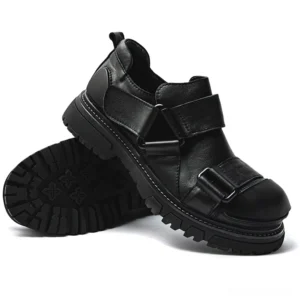 Solid black full grain leather gothic punk loafers with velcro straps and chunky rubber sole, three-quarter view and front sole