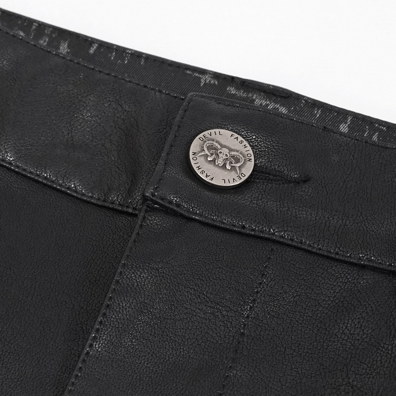 Close-up detail of gothic punk pants waist button and branded metal hardware on black fabric