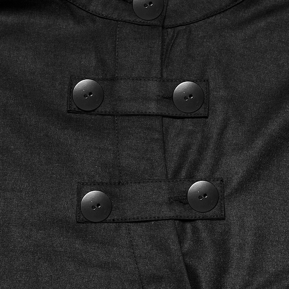 Top-down close-up of black gothic punk shirt fasteners showing matte black round buttons and fabric strap hardware accents