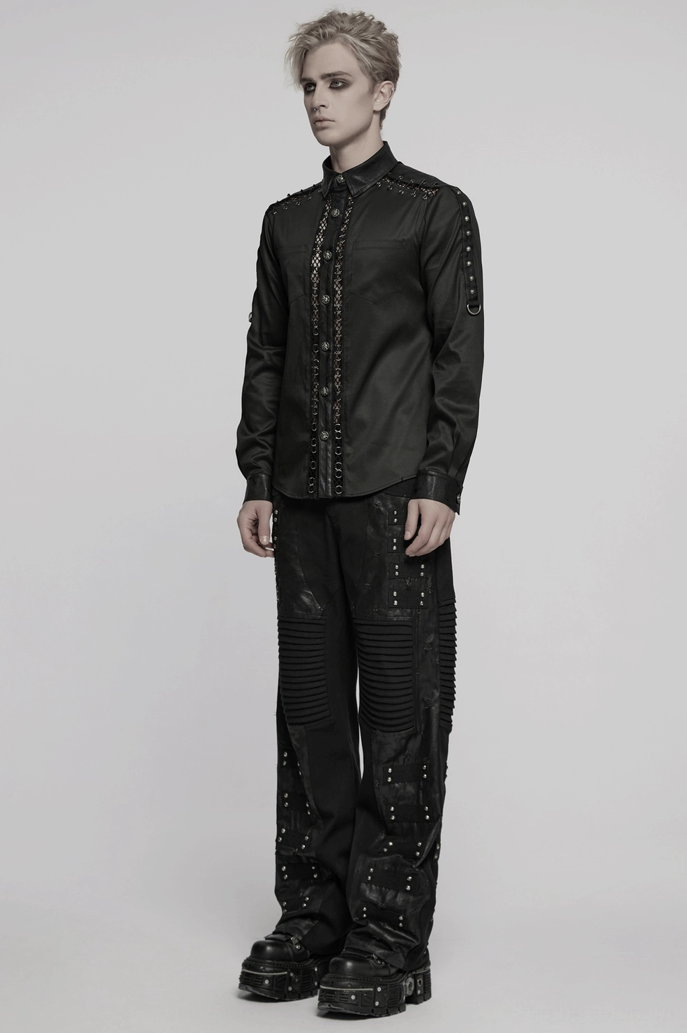 Gothic punk shirt close-up showing eyelet lace trim pattern, metal button detailing, and black matte fabric surface