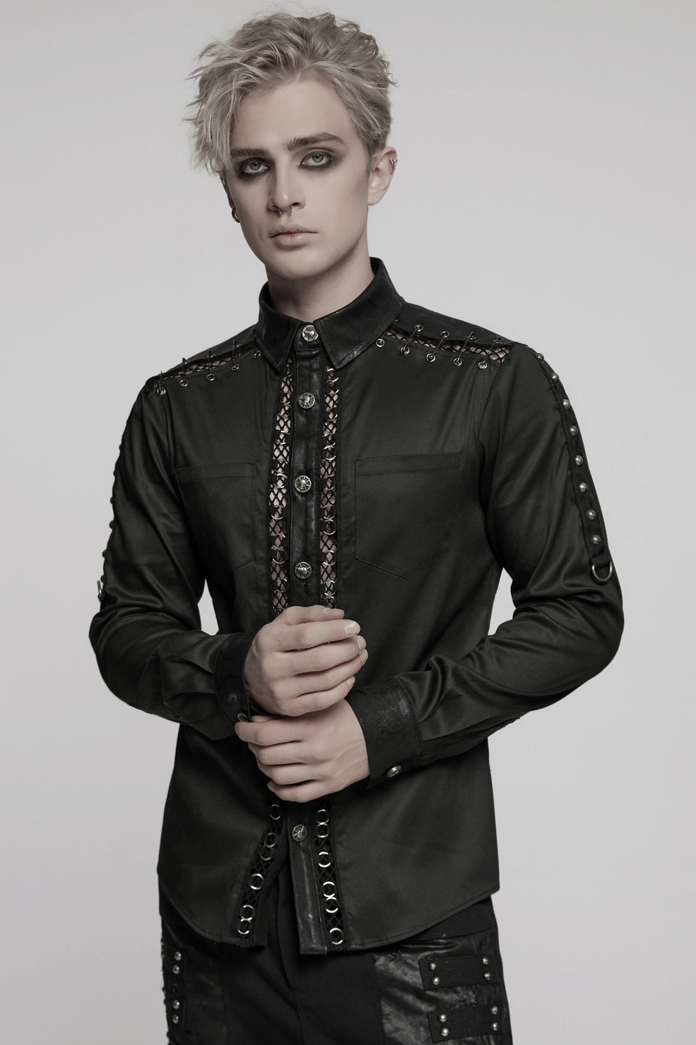 Gothic punk shirt detail showcasing faux leather panels, iron ring webbing, and studded architectural design elements