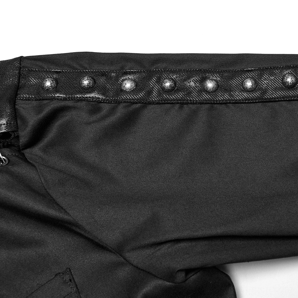 Close-up shoulder detail of gothic punk shirt showing metal stud embellishments, faux leather panel, and woven fabric texture