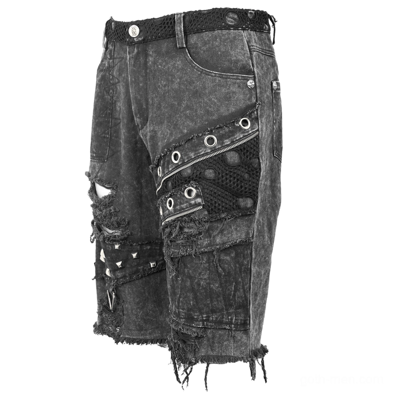 Three quarter front angle of black denim shorts showing mesh eyelet panel and rivet accents with frayed raw hem detail