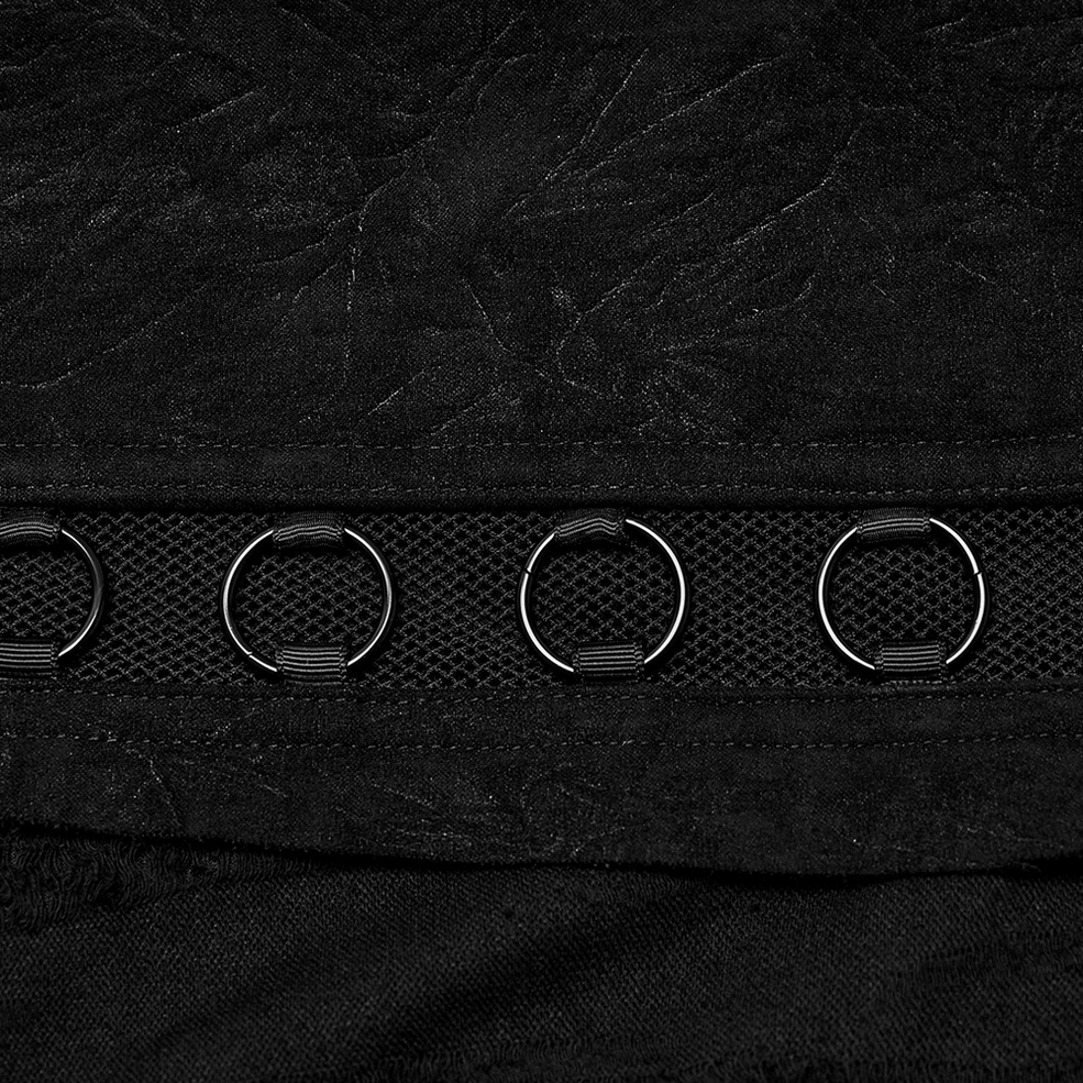 Macro detail shot of black distressed fabric with metal D-rings and mesh trim hardware on gothic punk skirt