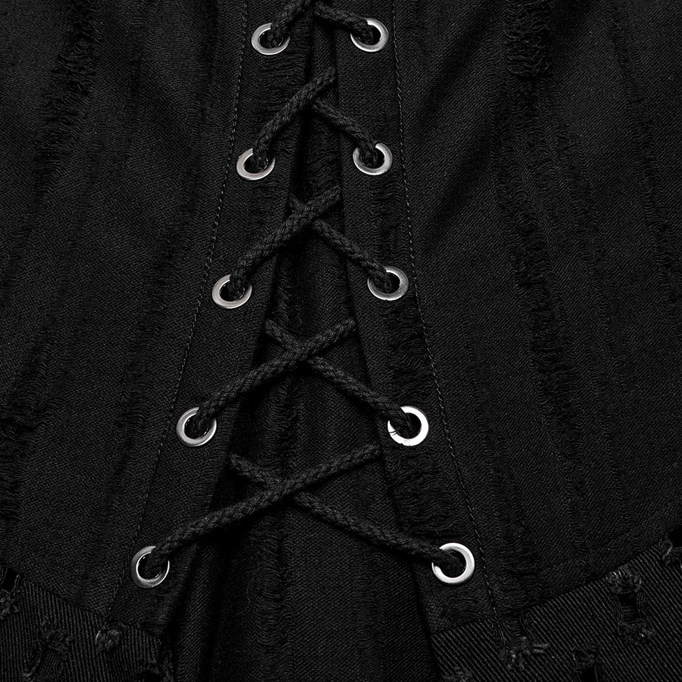 Close-up macro view of black woven lacing cord and metal eyelet fasteners with frayed distressed edges