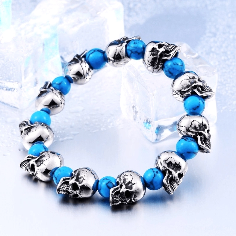 Skull bead elastic bracelet styled on ice cube decorative background, silver-blue punk jewelry aesthetic