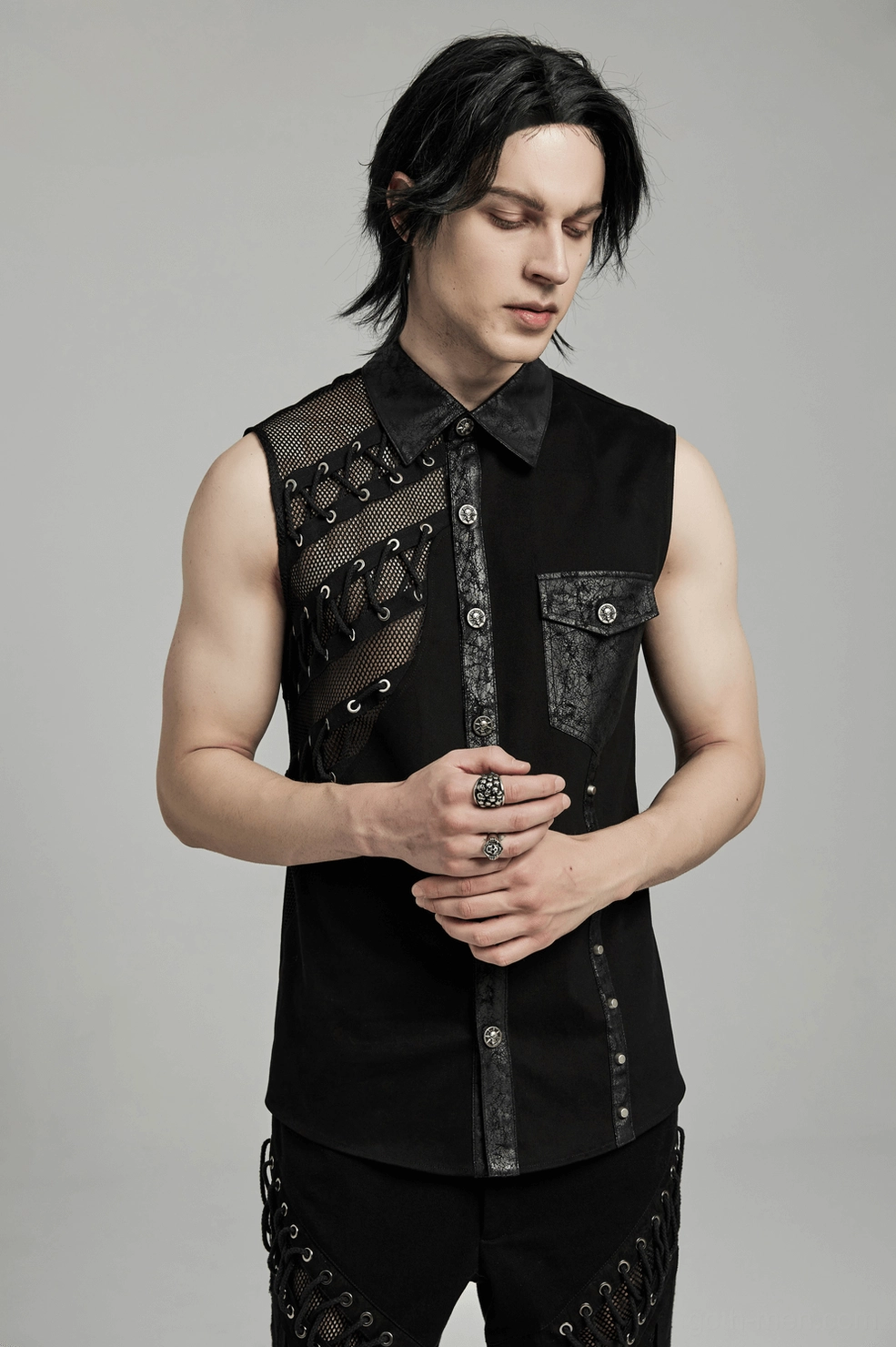 Men's alternative fashion gothic punk sleeveless shirt with mesh and studded hardware worn styling reference