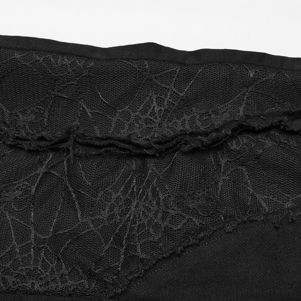 Male model rear view wearing fitted black gothic pants with spider mesh panels and ankle button closures