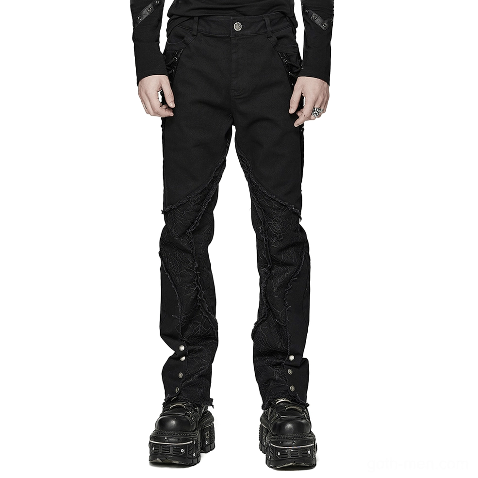 Male model wearing black spider mesh gothic punk pants with metal eyelets and ankle buttons, front view studio shot