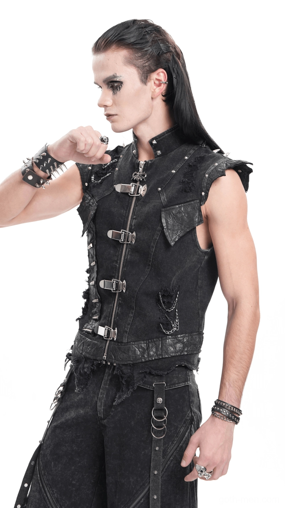 Detail view of black gothic punk denim vest shoulder spikes hardware and chain attachment mechanics