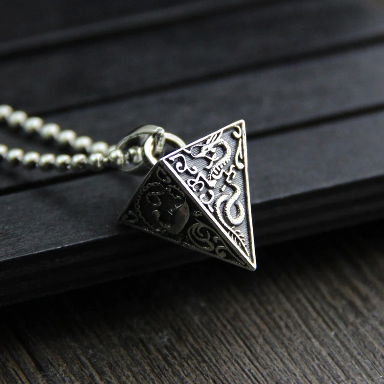 Gothic pyramid silver pendant with bead necklace chain featuring dragon embossments and darkened vintage silver tone, side view
