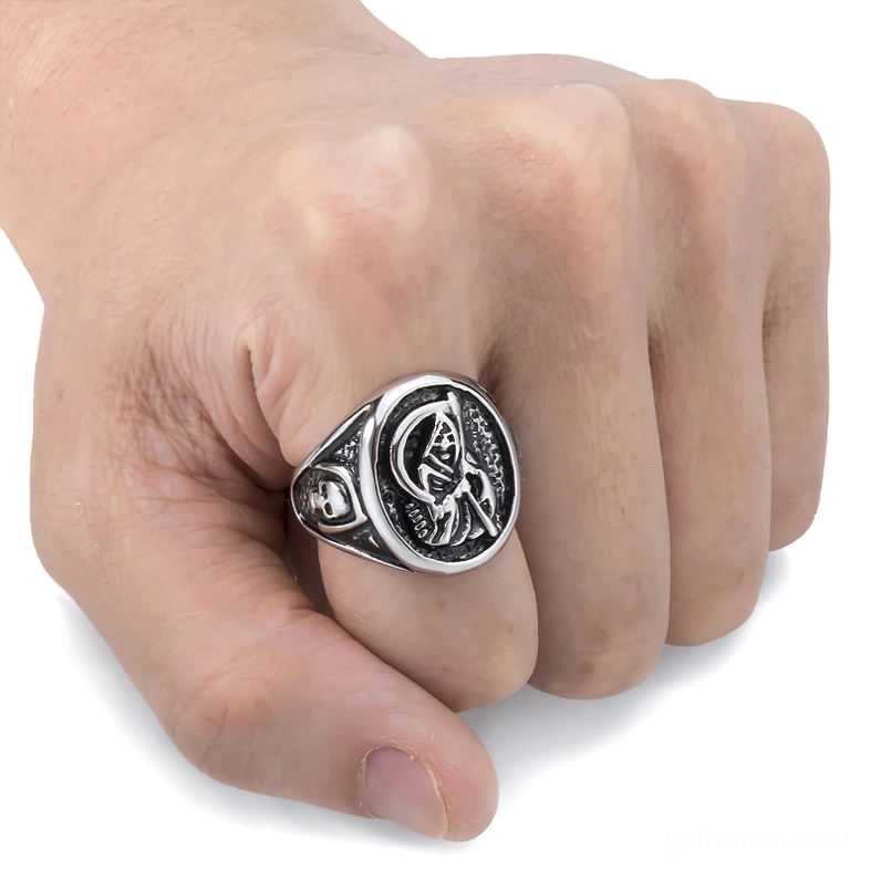 Side close-up of grim reaper stainless steel gothic ring worn on index finger displaying pattern clarity
