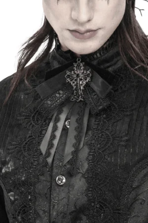 Gothic cross ribbon bow brooch worn on textured black lace shirt, detailed front view