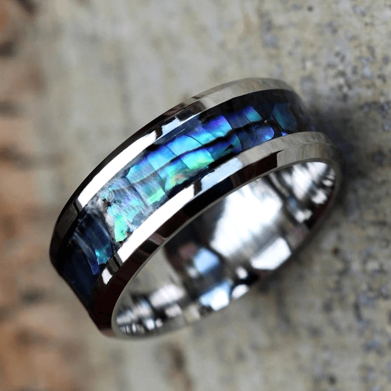 Abalone inlay ring worn on finger side view displaying layered shell and metal design