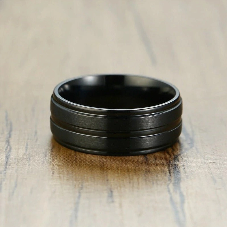 Black gothic ring upright standing position top-down flat lay on wooden table background
