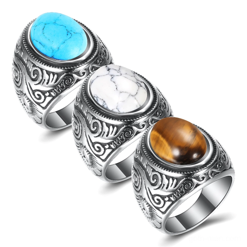 Set of three vintage gothic stone-inlaid stainless steel rings in different stone colors displayed together, oblique side view
