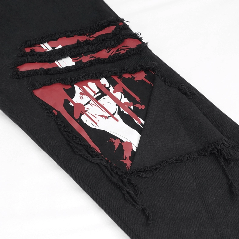 Close-up of distressed tear detail on gothic ripped trousers revealing red and white graphic print underneath