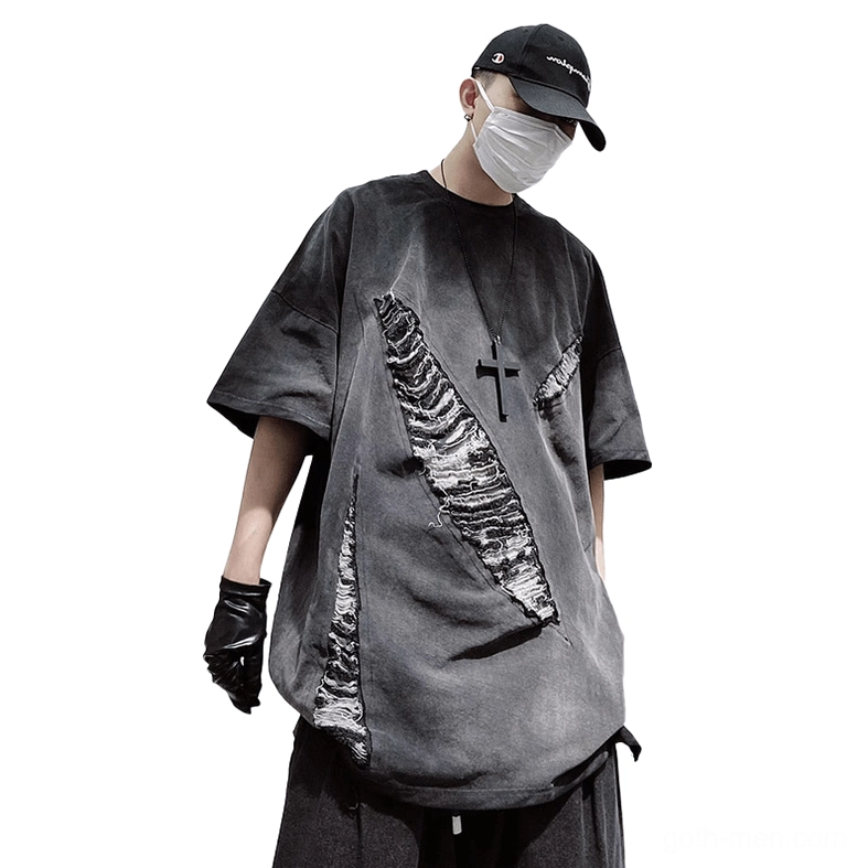 Oversized distressed gothic ripped T-shirt in charcoal gray with diagonal frayed patches, front three-quarter view on male model