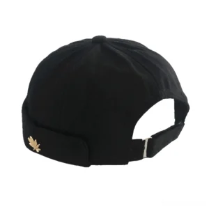 Black gothic rivet brimless cotton skullcap with adjustable back strap, rear quarter view showing maple leaf metal hardware detail